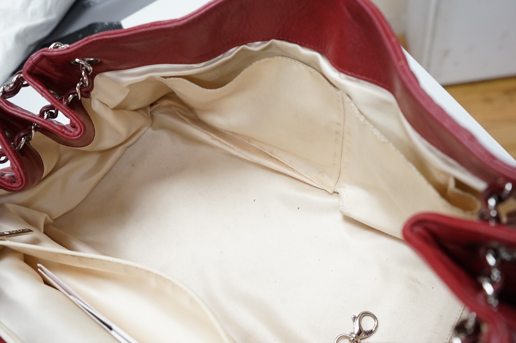 A Chanel East West dark red quilted leather flap shoulder bag with silver hardware, date code 12115484, with original receipt, dust cover and box, 35cm wide, Provenance: purchased by the vendor in Selfridges